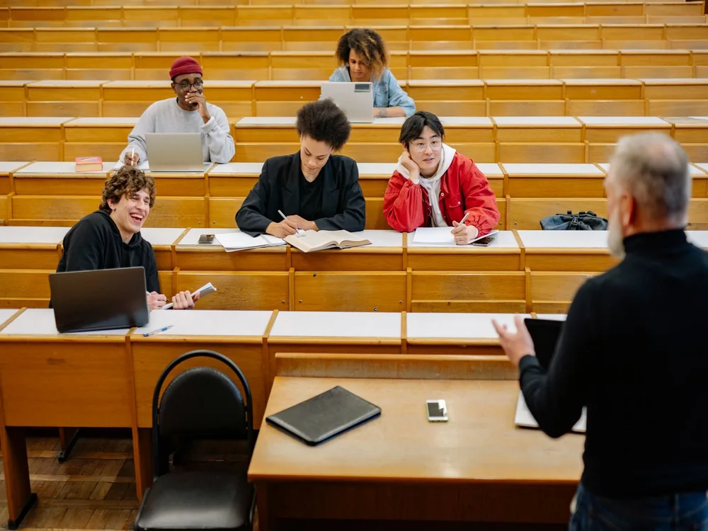A professor teaching students in a lecture hall