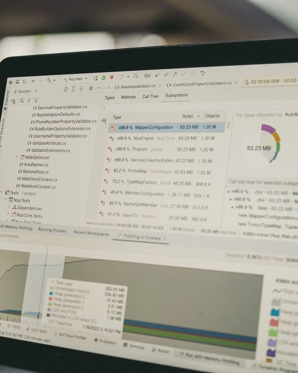 A laptop screen showing a code editor alongside data-analysis panels