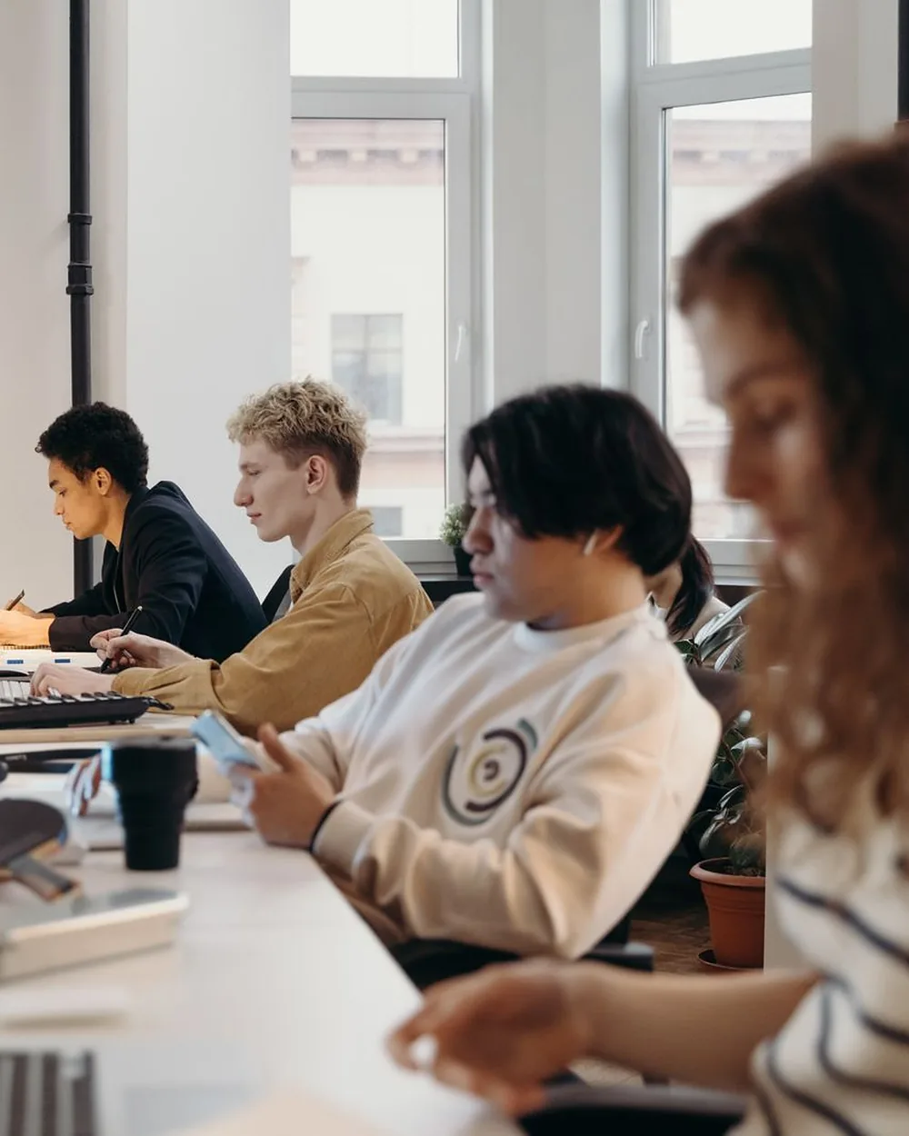 Colleagues working side by side in a bright shared office