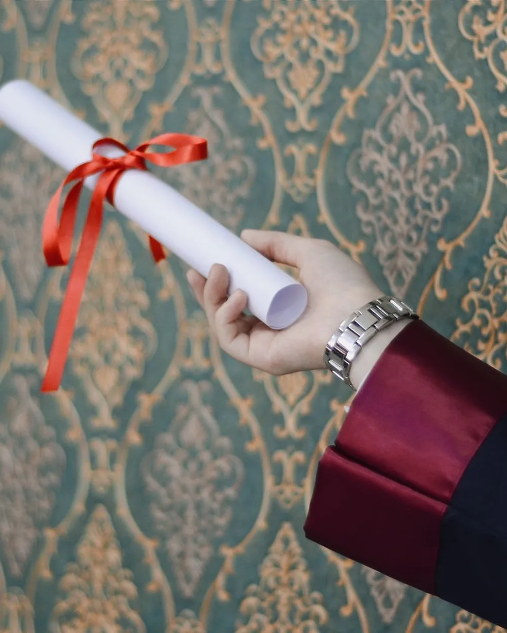 A person holding up a diploma